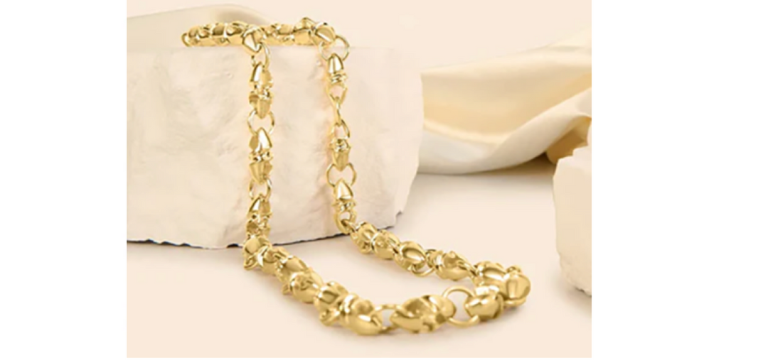 A young man in a white t-shirt wearing a gold oval link necklace by Sziro Jewelry in Coral Springs 